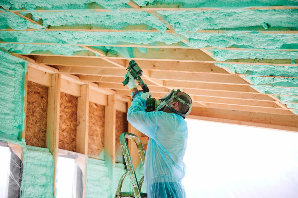 worker-spraying-polyurethane-foam-insulating-wooden-frame-house in Fayetteville AR